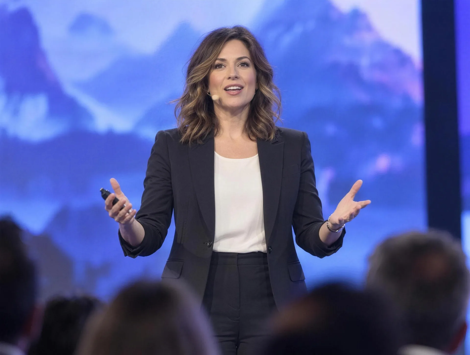A speaker on a big conference stage